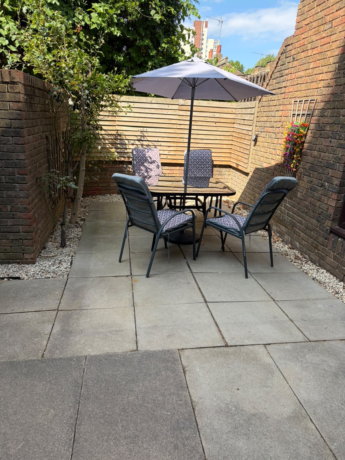 Completed clean patio with modern dining set and parasol